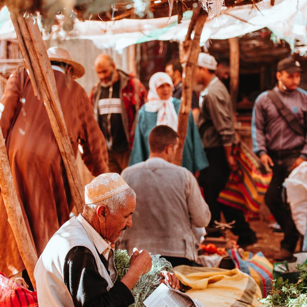 man-at-market-with-newspaper